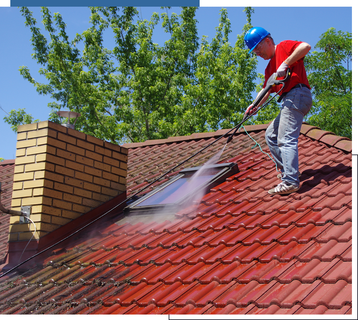 Man cleaning roof with pressure washer